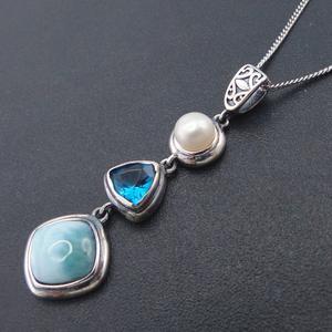 Amulet with pearl, blue crystal, and larimar stones for emotional balance and feminine power