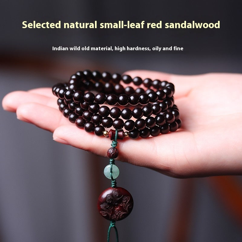 "Prosperity talisman bracelet with jade and red beads, crafted for wealth and protection."